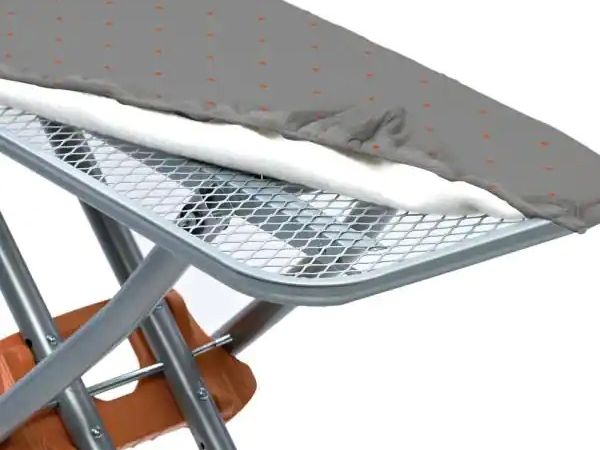 The cloth cover of the ironing board is unfolded to display the expanded metal support.