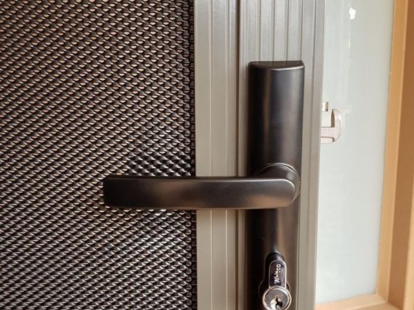 Partial details of heavy duty DVA mesh security door with handle