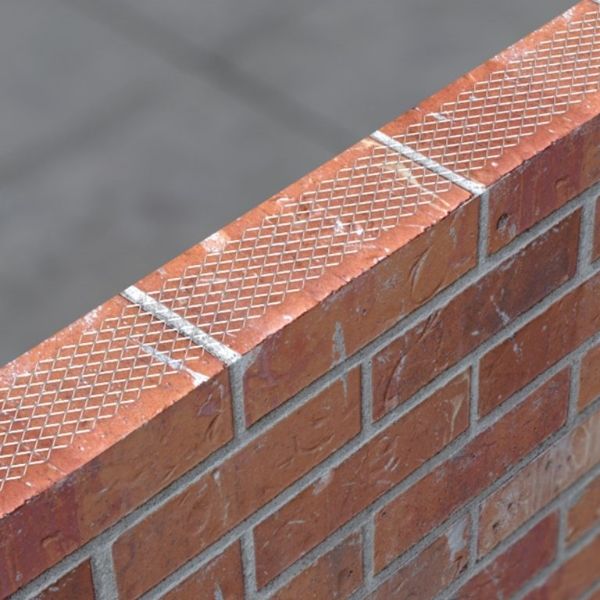 Expanded metal lath is placed on red bricks.