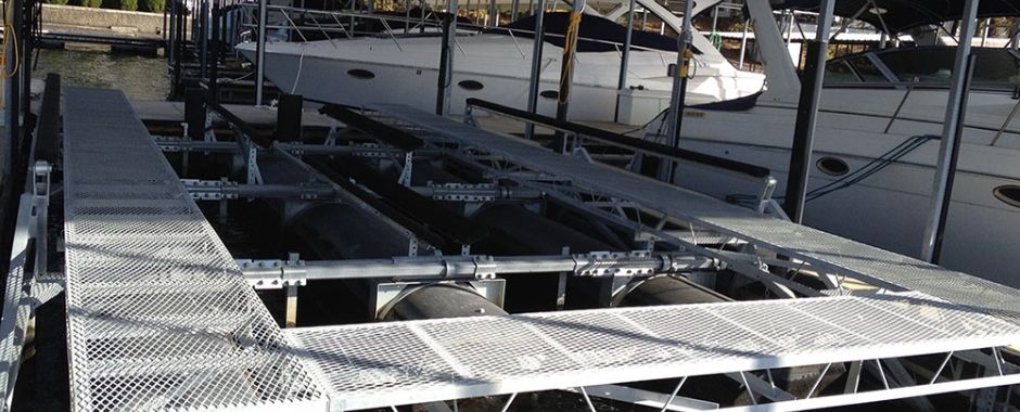 White expanded metal grating is installed above the water surface.