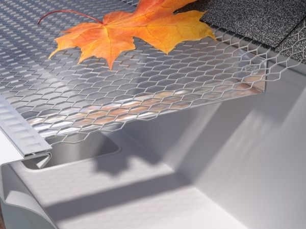 A maple leaf falls on the expanded metal gutter guards.