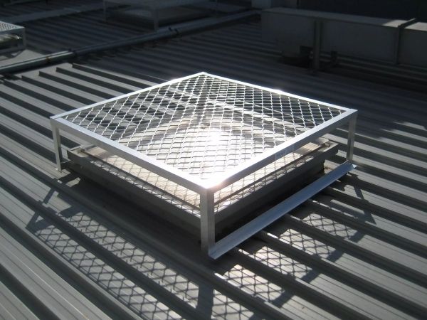A square expanded metal guard covers the skylight for protection.