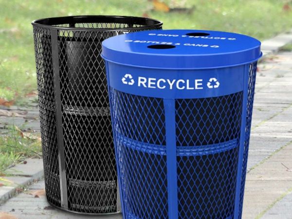 A black and a blue expanded metal trash cans are placed on the ground.