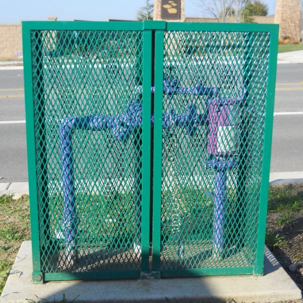 Green expanded metal machine guards are used to protect the outdoor pipeline system.