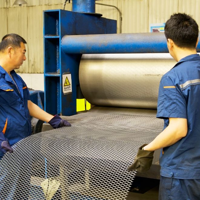 Our workers ore producing expanded metal before the machine.