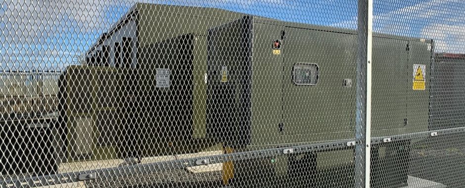 Expanded metal safety fence is installed around the military facility.